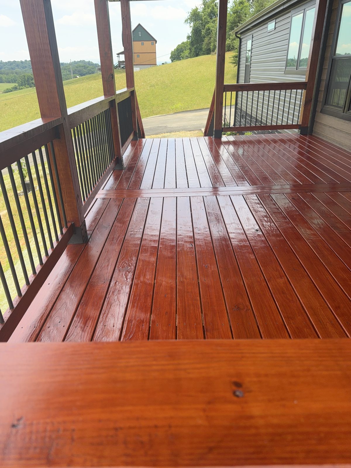 Brushed-on PPG ProLuxe Mahogany deck boards showing deep semi-gloss sheen