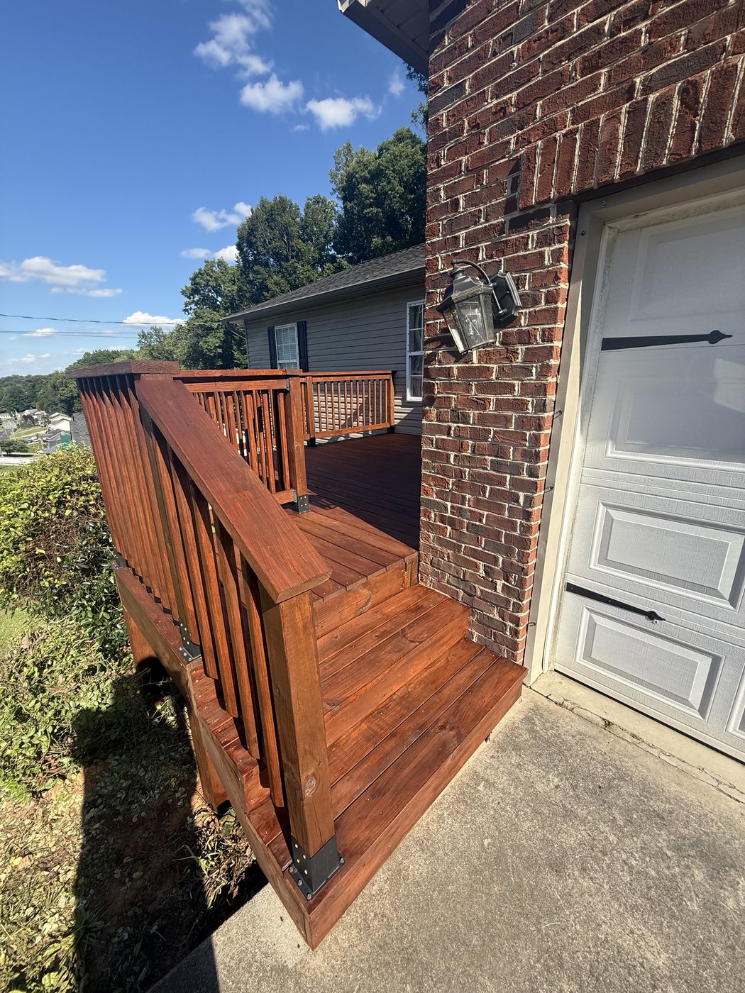 Deck after SuperDeck Exotic Timber Oil Red Mahogany, second angle showing the deep mahogany color on steps and railing