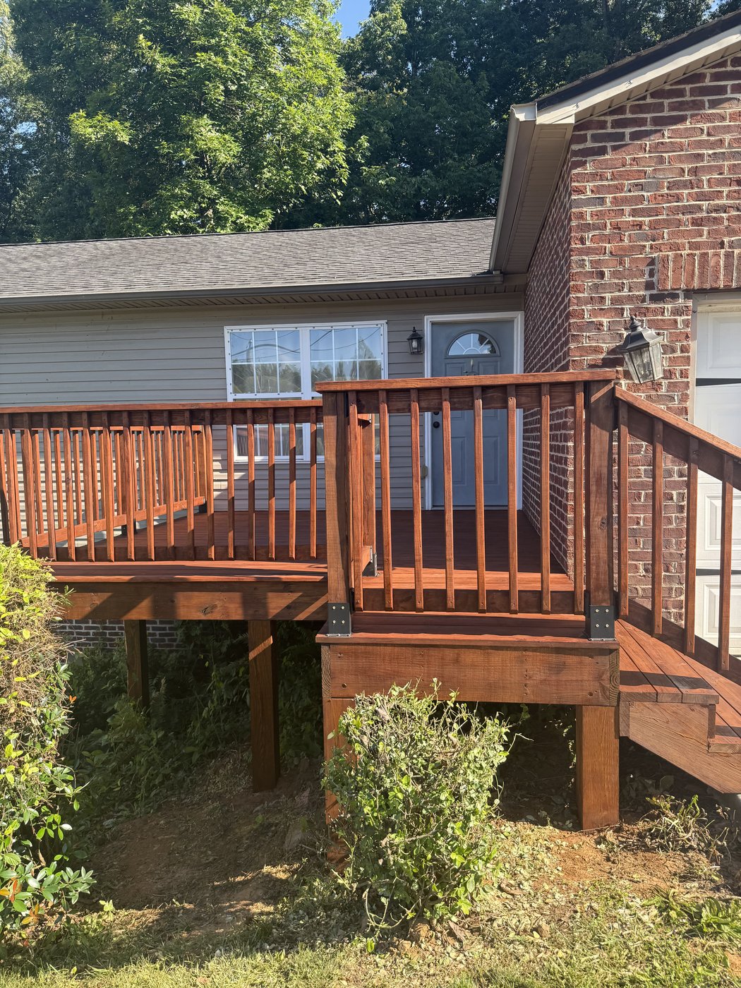 Deck and railing after SuperDeck Exotic Timber Oil in Red Mahogany — dark reddish-brown