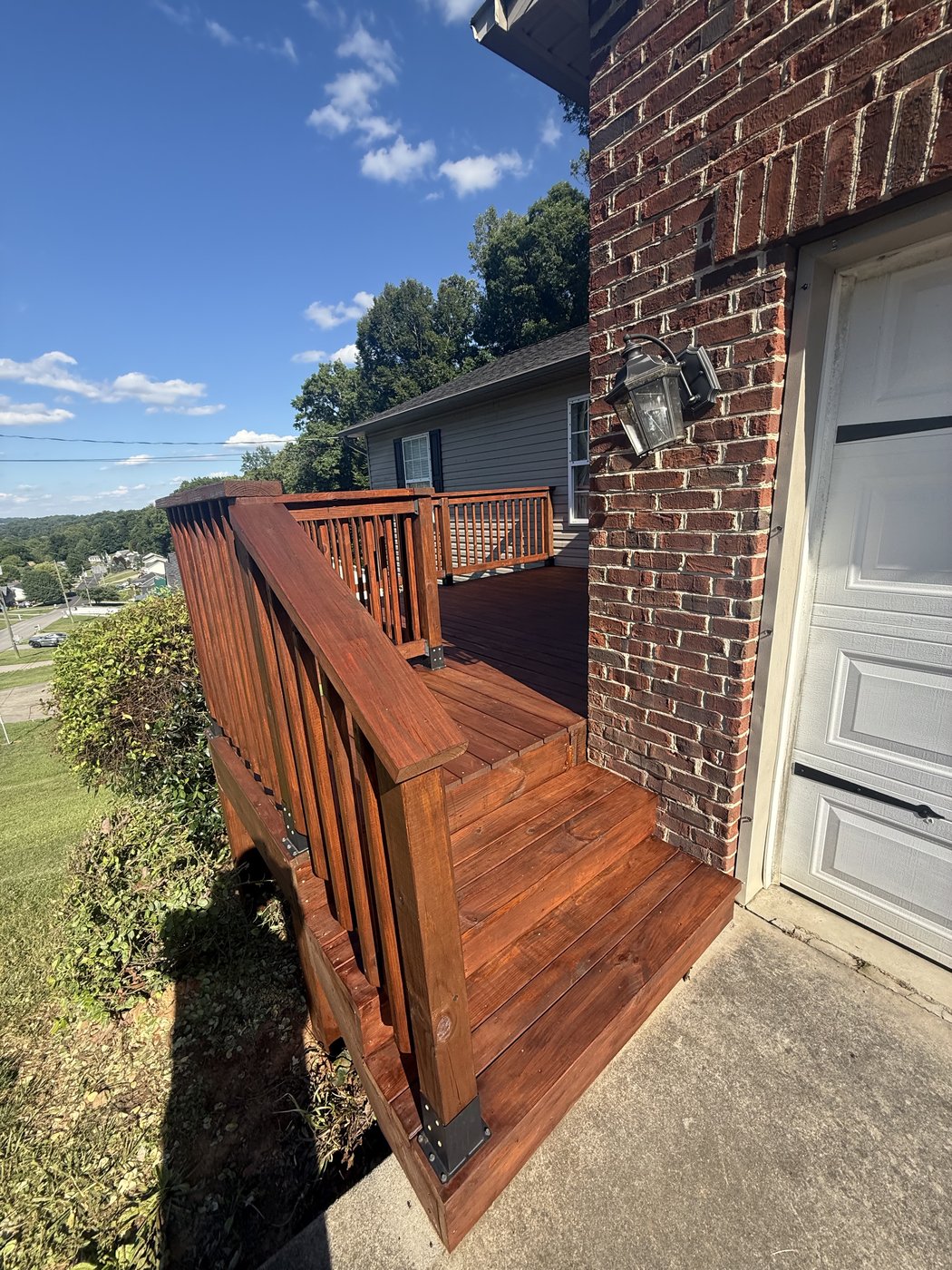 Stained deck boards and steps in SuperDeck Exotic Timber Oil Red Mahogany, rich mahogany color