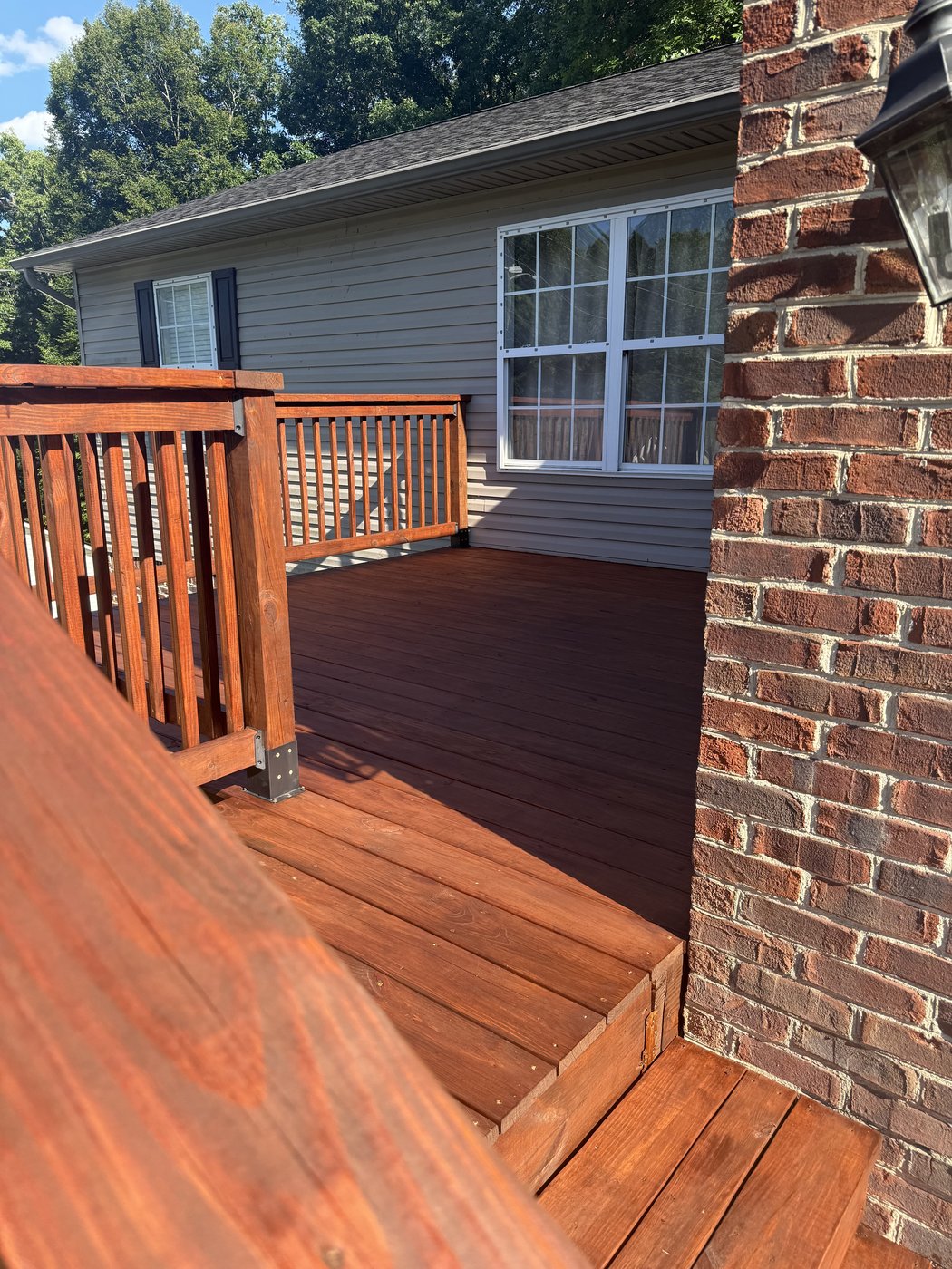Deck railing close-up after Sherwin-Williams SuperDeck Exotic Timber Oil Red Mahogany