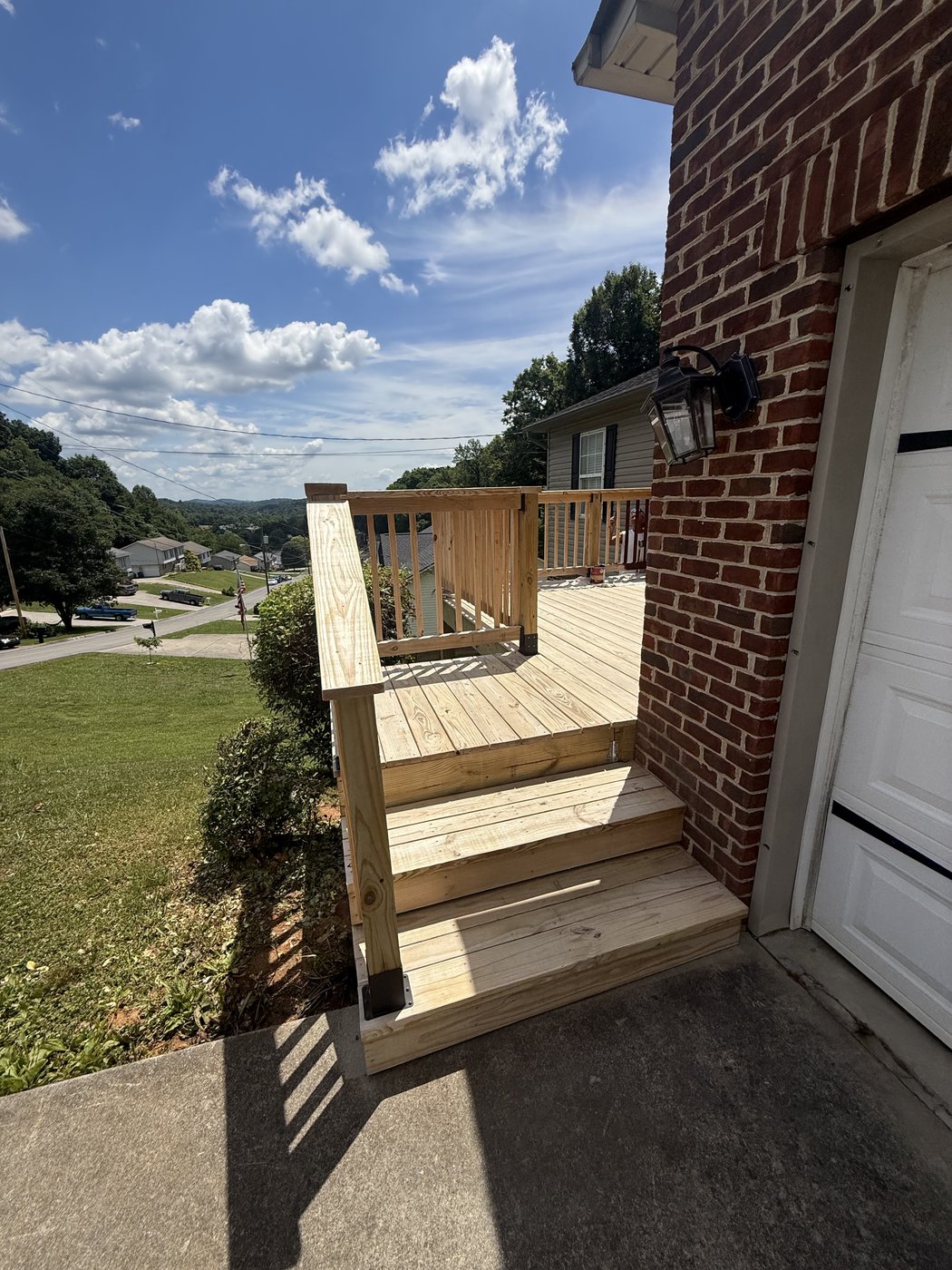 Pressure-treated pine deck steps and railing before staining, second angle — Kingsport, TN